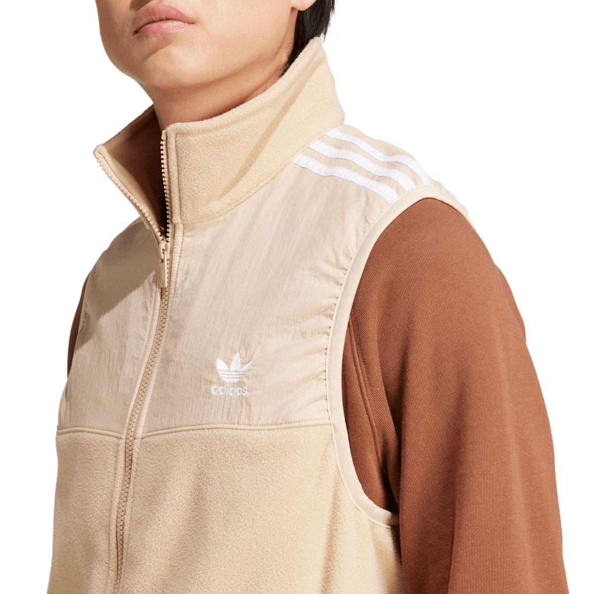 adidas Originals beige microfleece vest close-up, high collar, trefoil logo, front zip