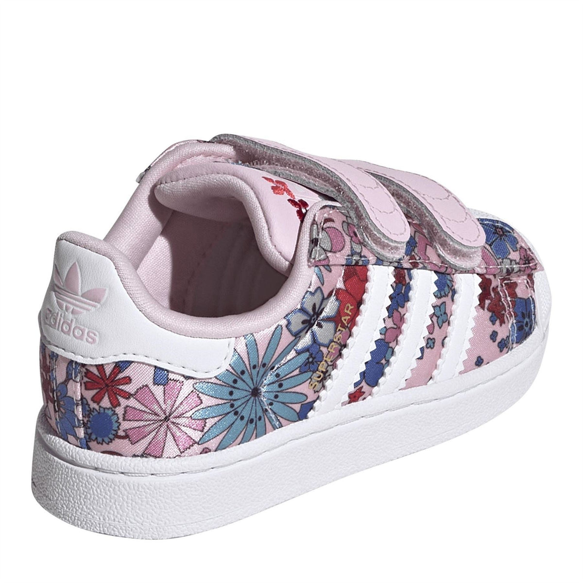 Pink and white sneakers with floral heel panel, padded collar, and white midsole