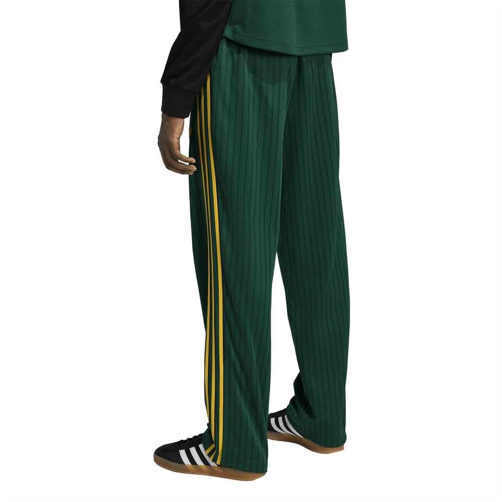 Adidas Originals Firebird track pants with yellow side piping and vertical rib texture