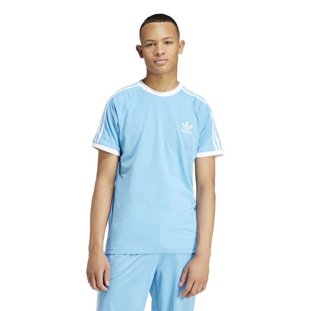 Light blue crew-neck T-shirt on model with adidas chest logo and three white stripes