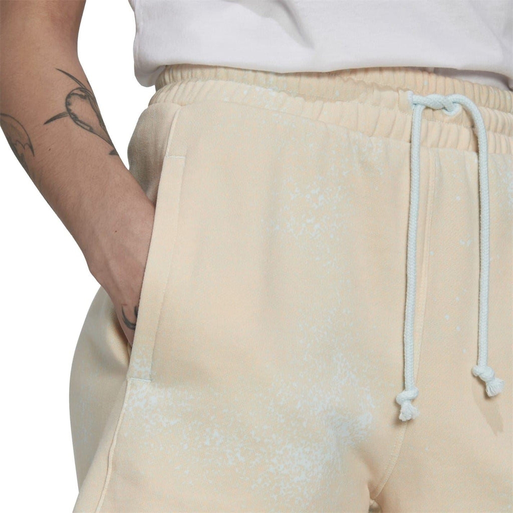 Cream drawstring waist sweat shorts with elastic waistband and hanging cords