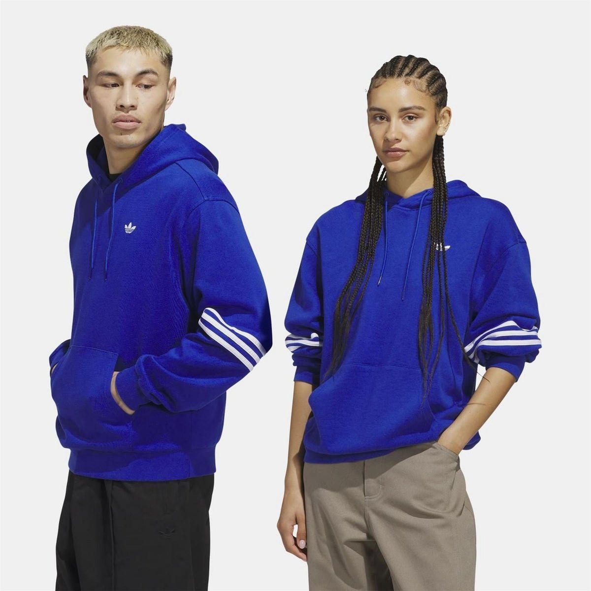 adidas Originals blue hoodie on model, front trefoil logo with striped sleeves