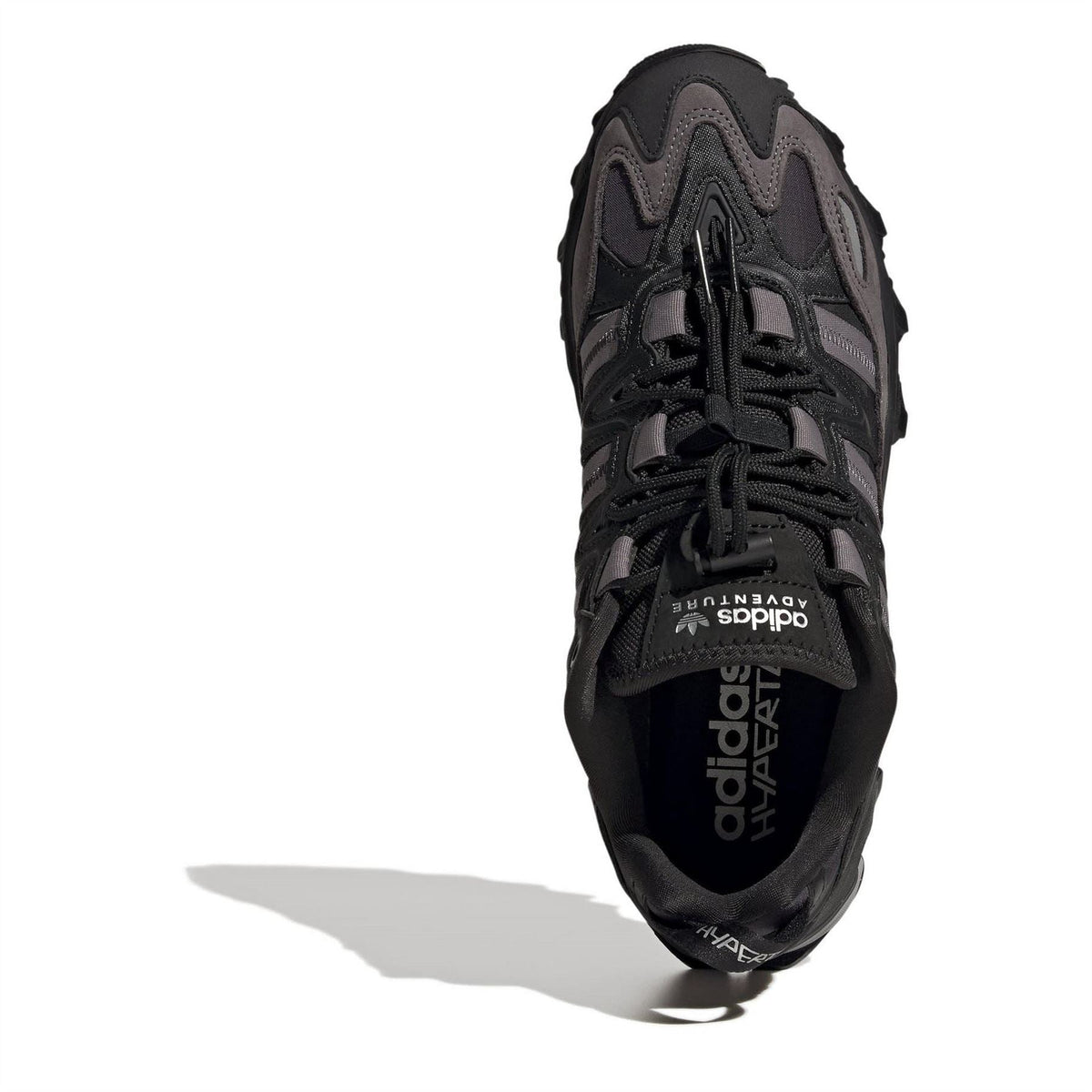 Black adidas sneaker with 'adidas' logo on side and lace-up front.
