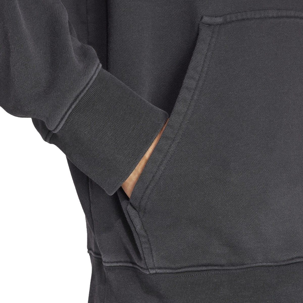Black hoodie sleeve and kangaroo pocket seam detail