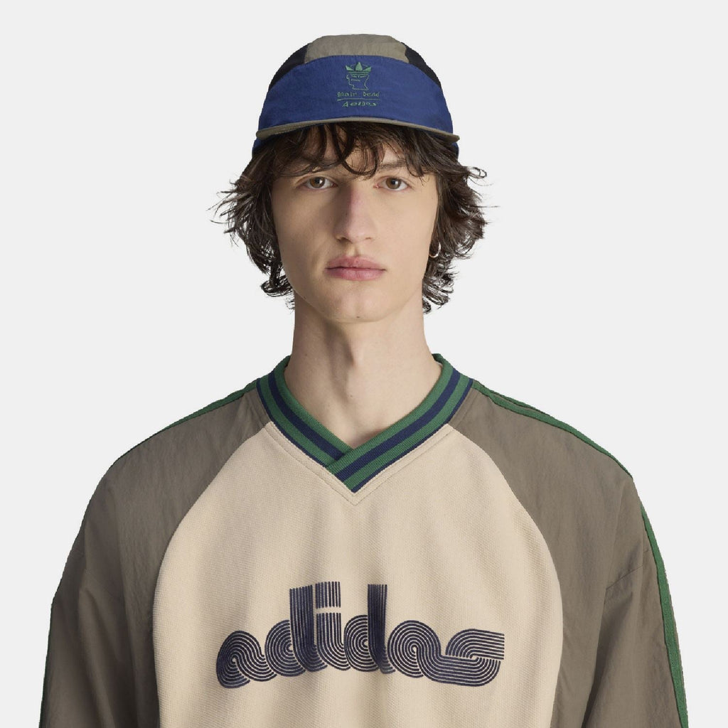 Two-tone cap worn by model, olive crown with blue band and dark mesh sides