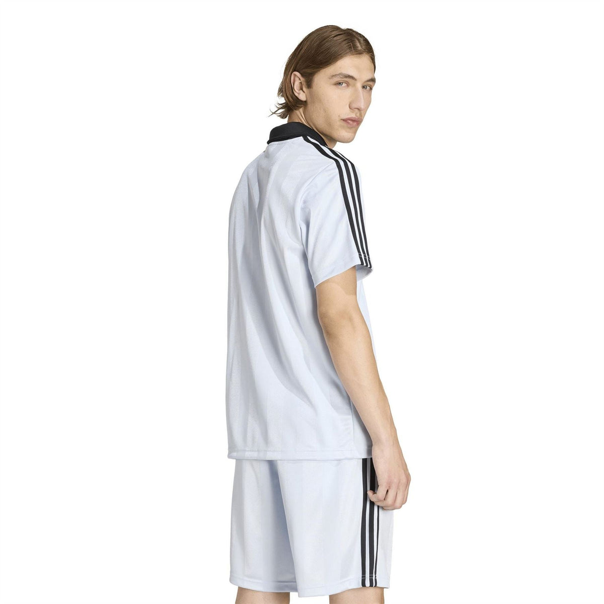 Light blue adidas polo shirt from side view with black collar and sleeve stripes