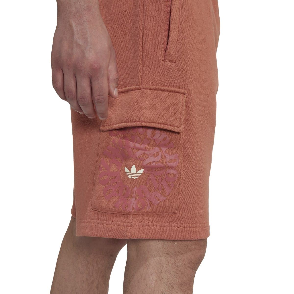 Rust-brown cargo shorts close-up of side pocket with adidas-style logo