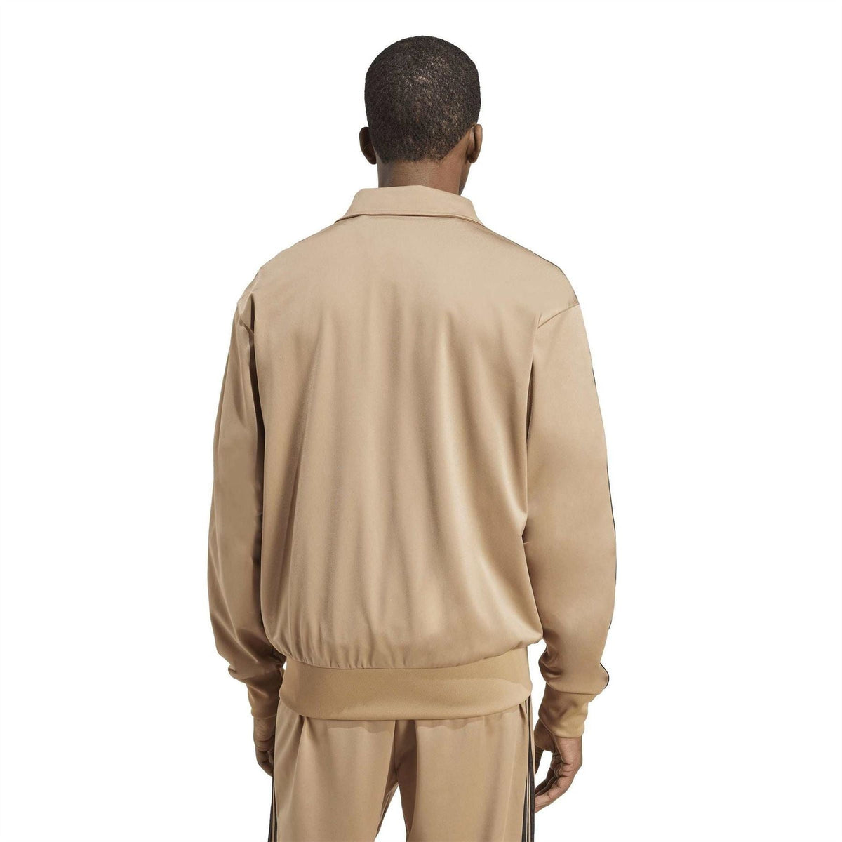 Tan track jacket back with stand collar and ribbed hem; black side stripes visible.