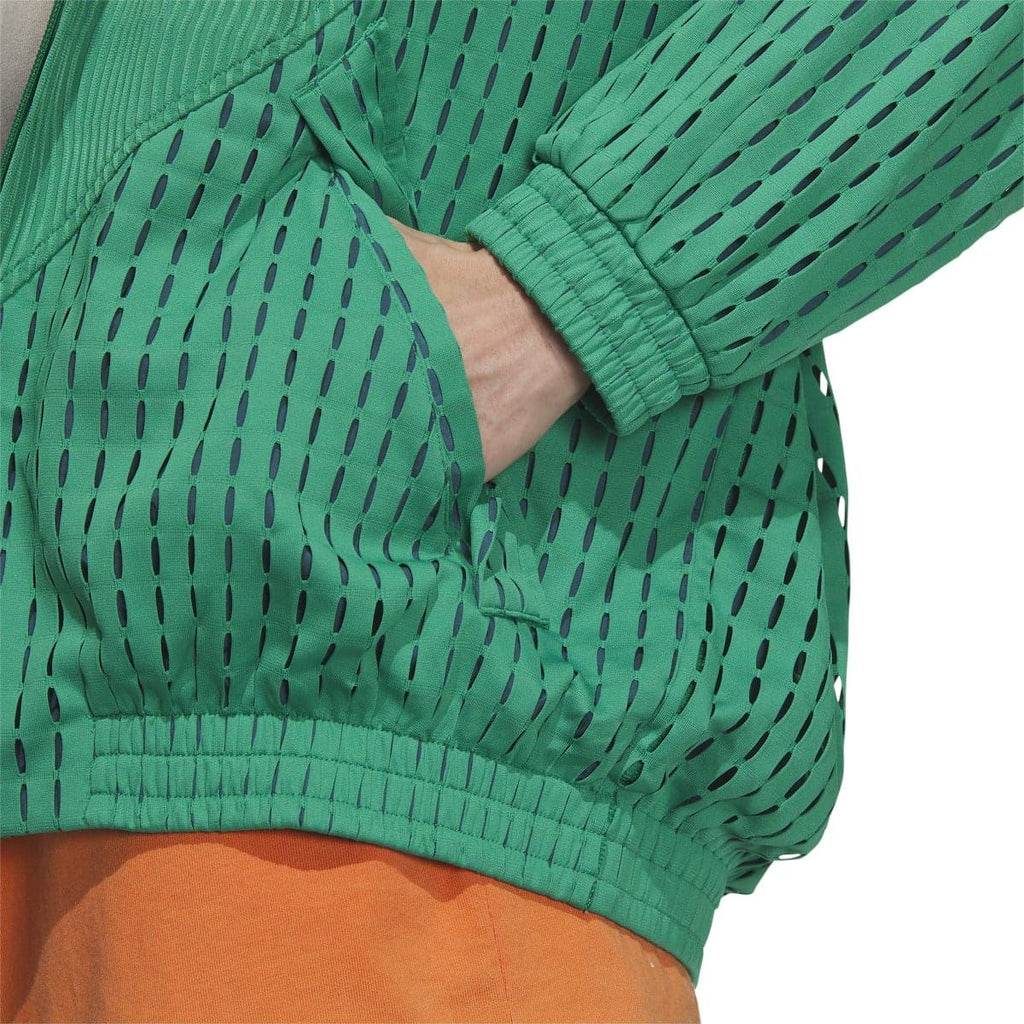 Green jacket sleeve close-up with perforated knit pattern and elastic ribbed cuff