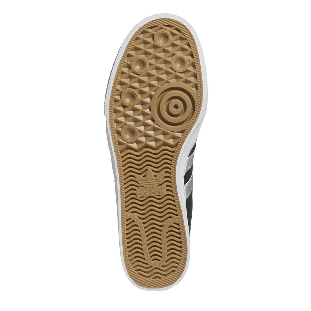 Black and white adidas Adiease outsole with tan rubber tread pattern