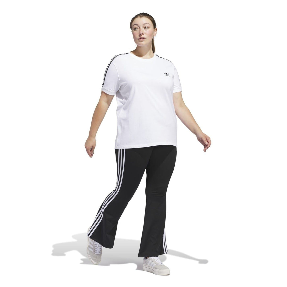 adidas Originals flared leggings for fitness and gym wear, black athletic pants with flared design and brand logo.