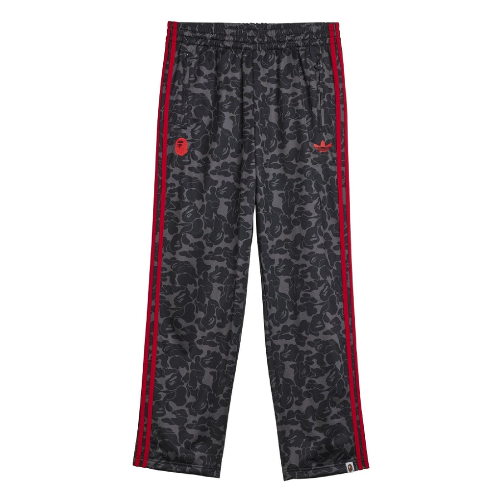 Black camo trackpants with red side stripes, elastic waistband, tapered leg.