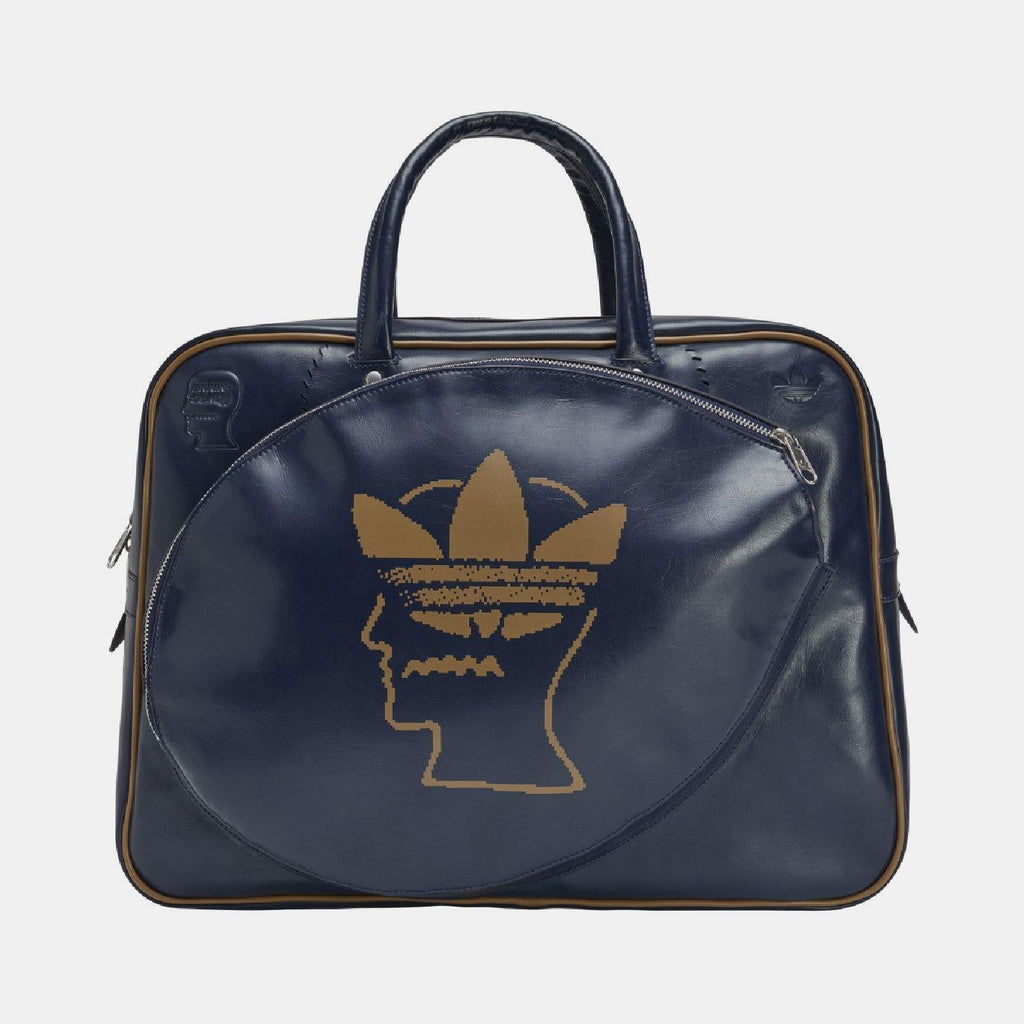 Navy duffel bag with top handles, side zippers, and gold Trefoil head logo on front.