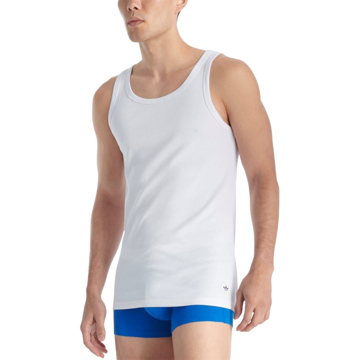 White adidas tank top front view: scoop neck, sleeveless cut, small logo at hem
