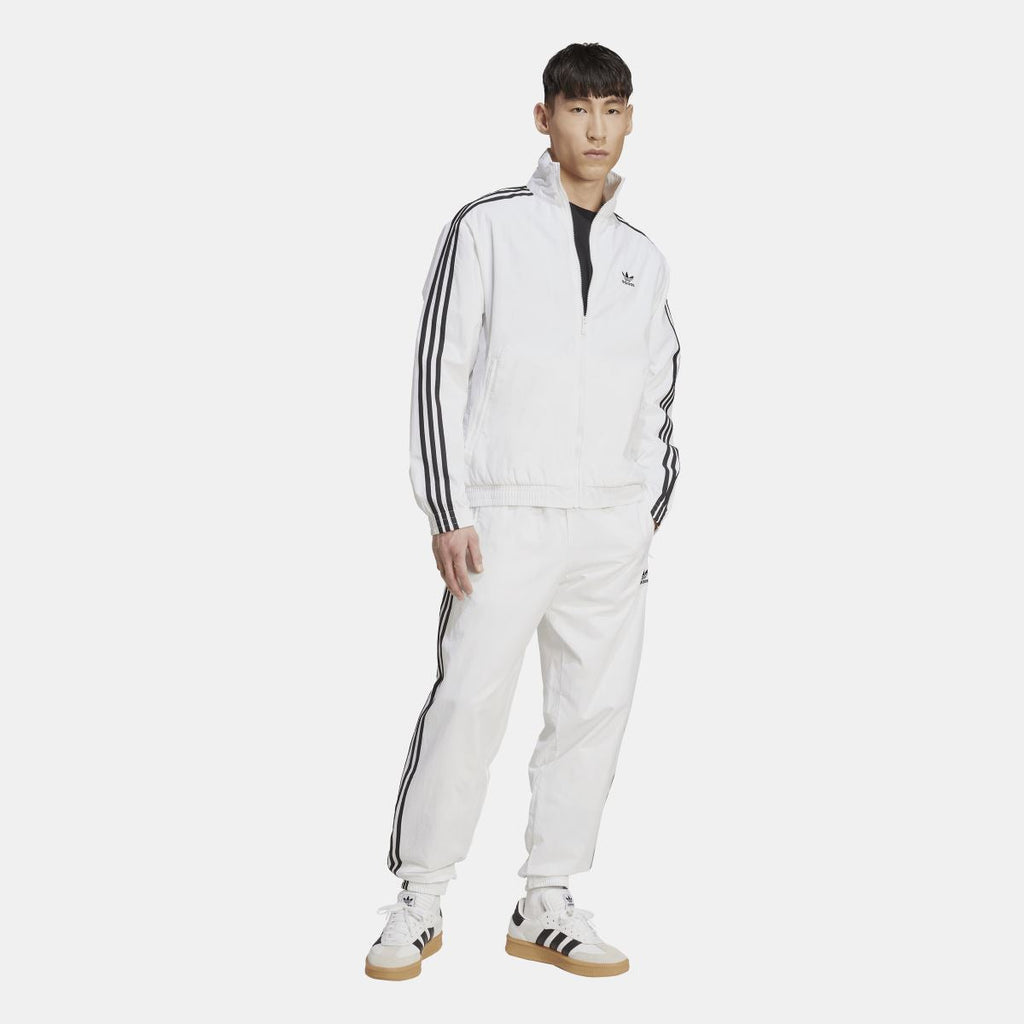 White adidas track top with zip front and black triple-stripe sleeves, full-body view