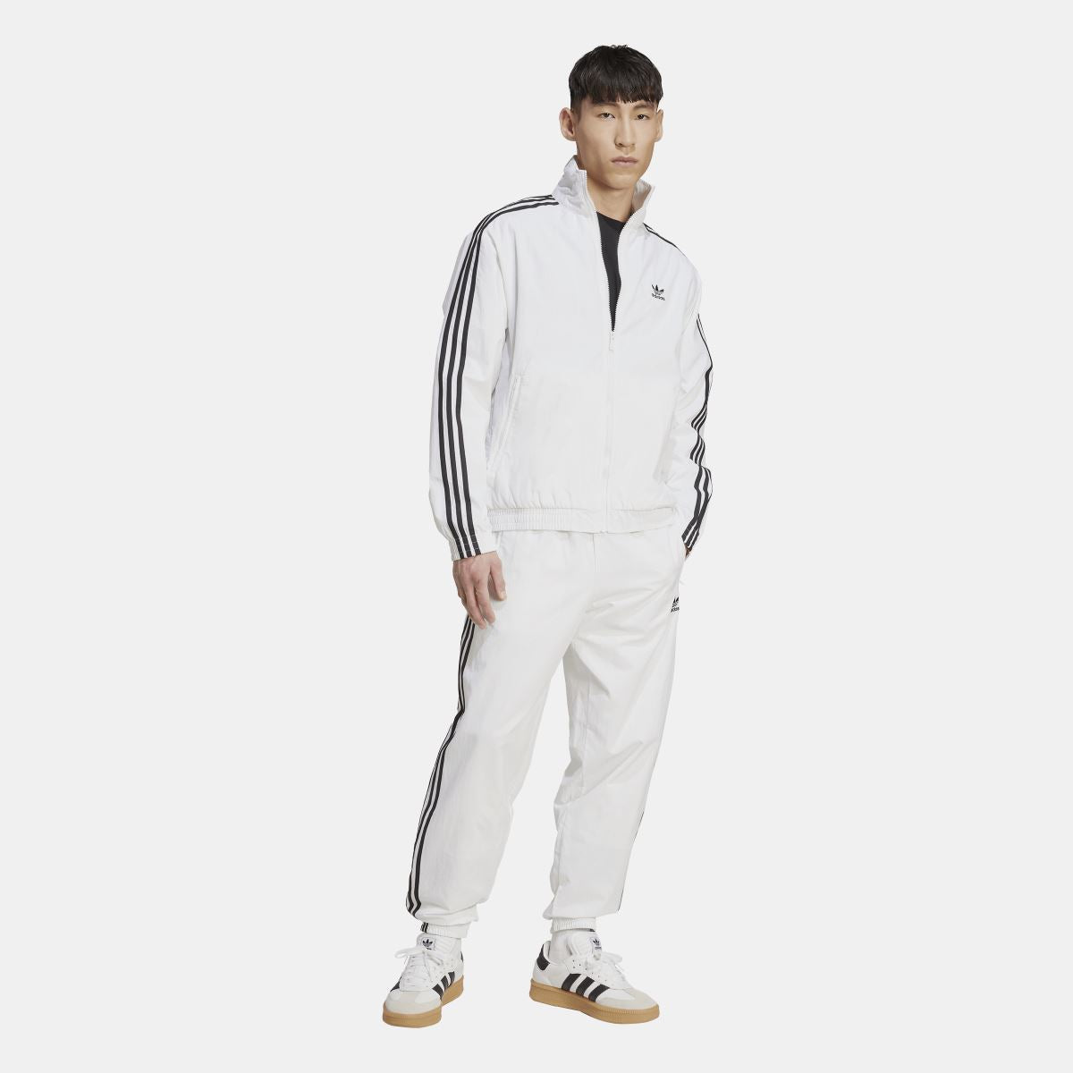 White adidas track top with zip front and black triple-stripe sleeves, full-body view
