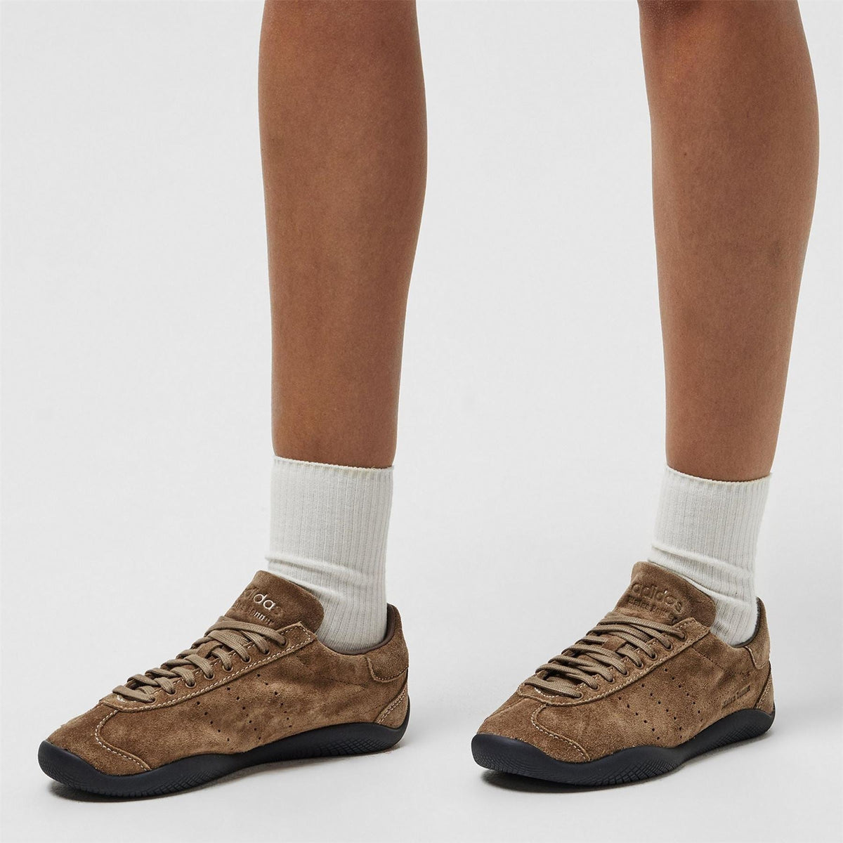 adidas Originals sneakers with white crew socks, earth-brown suede and black sole