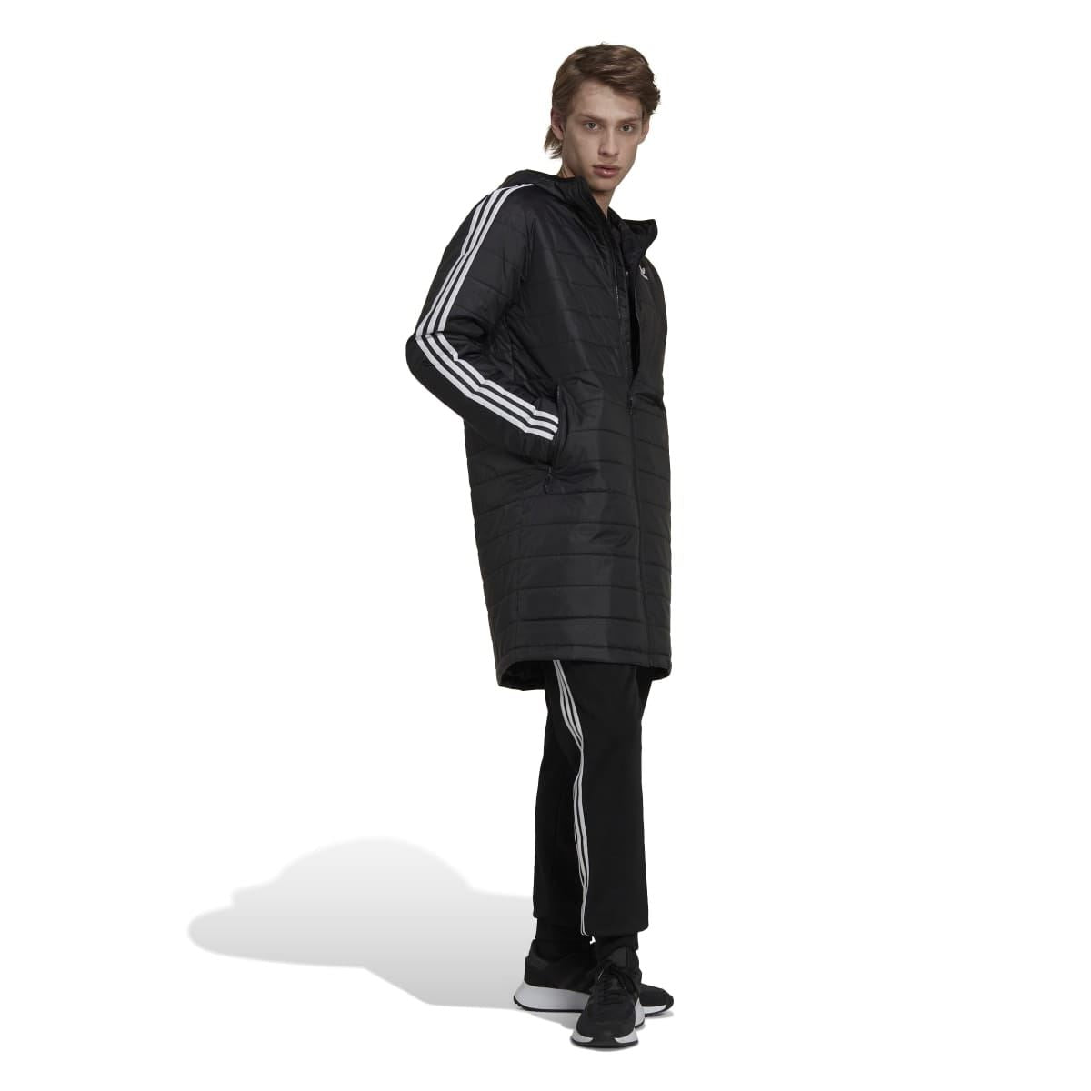 Black padded coat with hood and white 3-stripe sleeves; model in side profile.