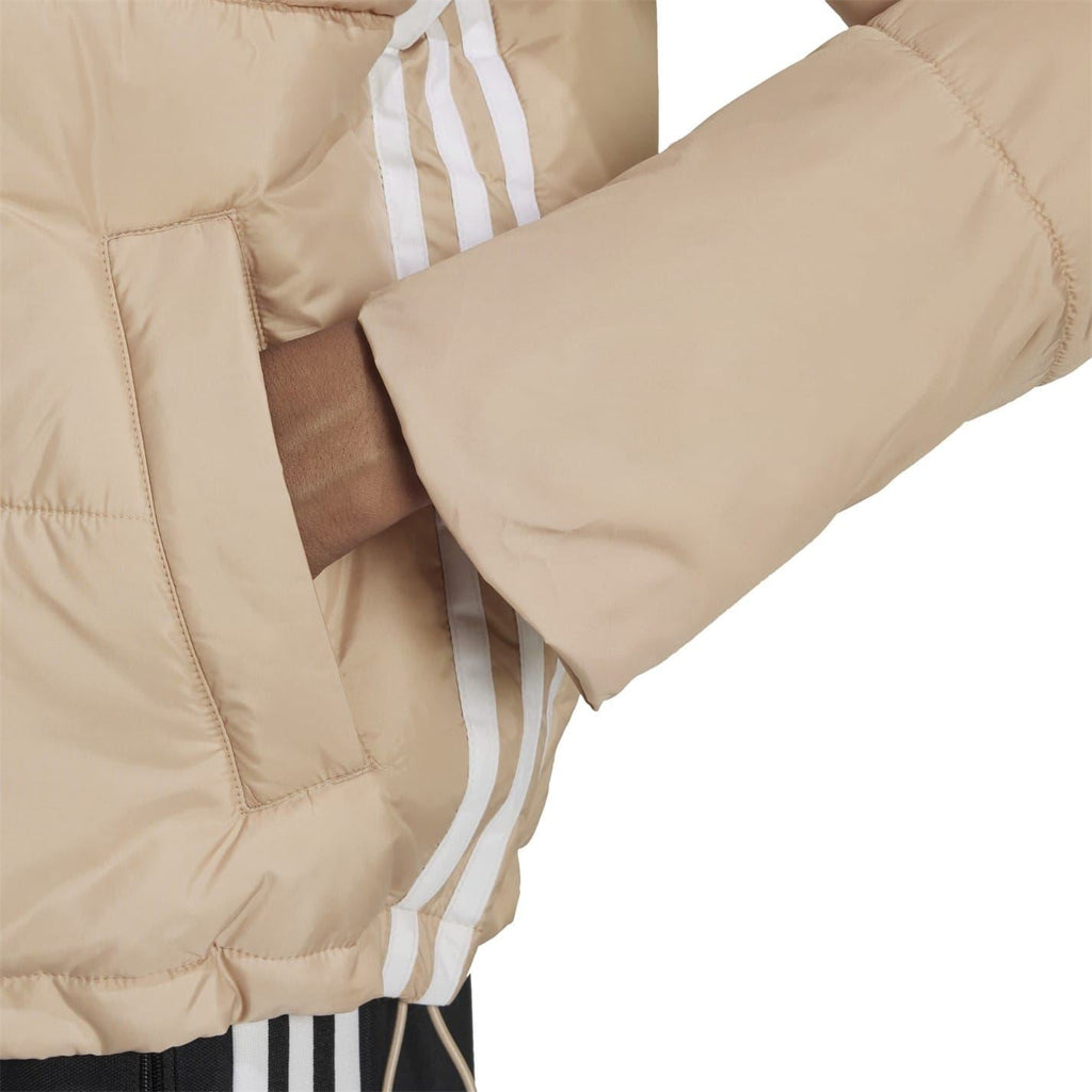Beige padded jacket sleeve and side seam detail with stitched paneling.