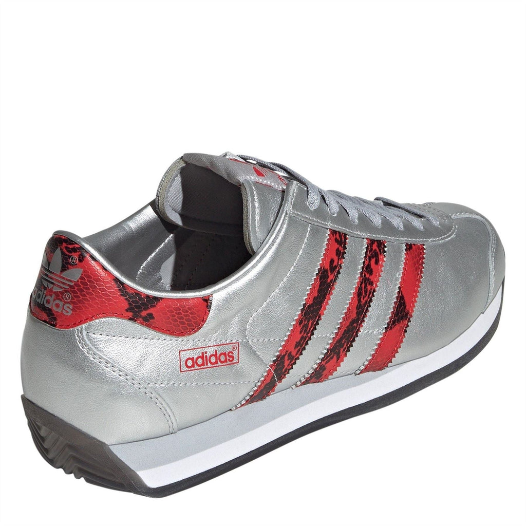 Silver adidas Originals sneaker with red interior lining and rear heel tab