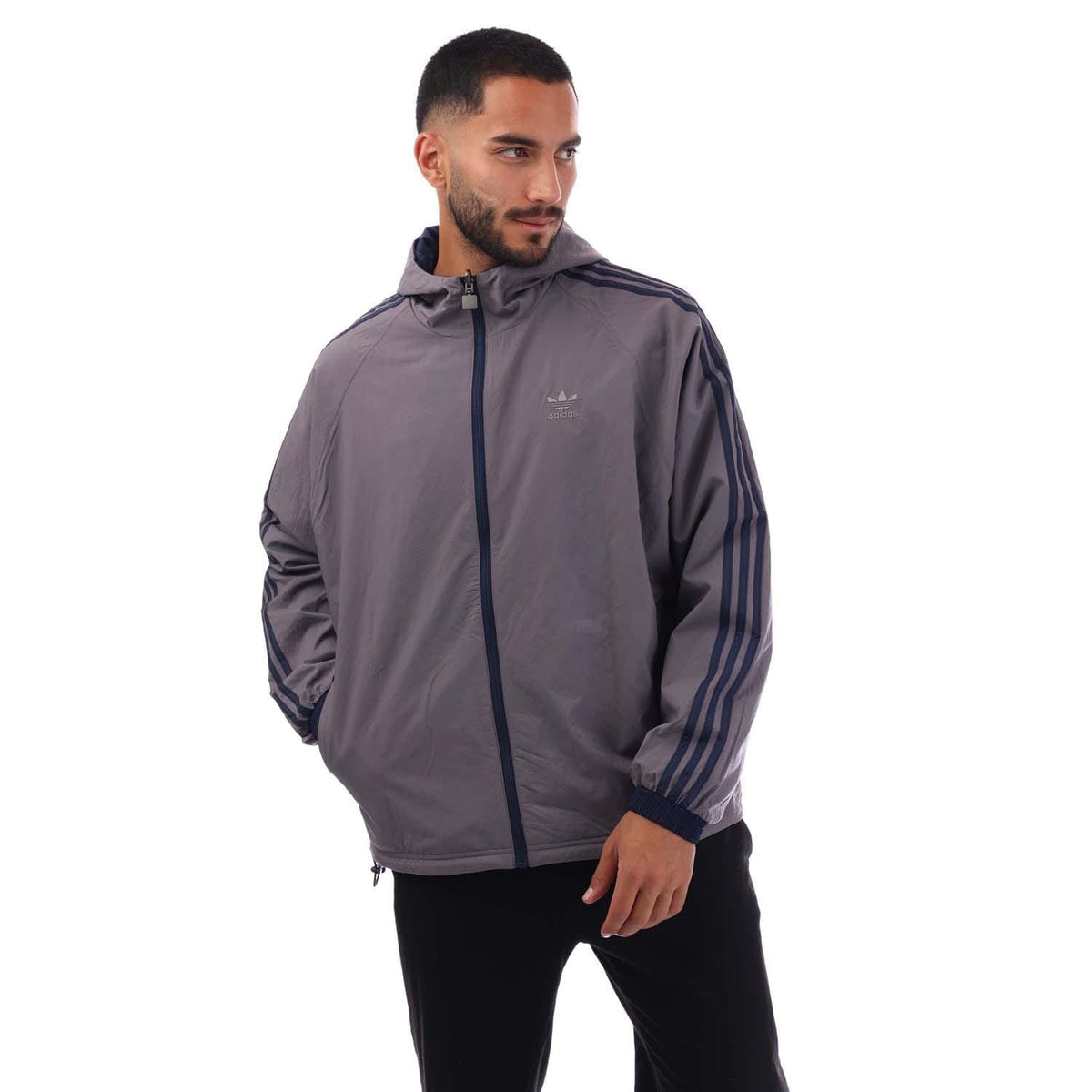 Reversible windbreaker jacket in gray with full zip, hood, and striped sleeves