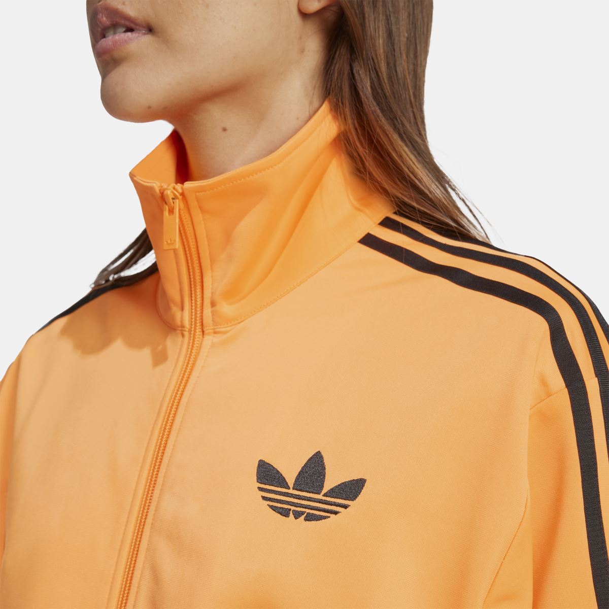 Orange track jacket collar with full zip and adidas trefoil logo on chest