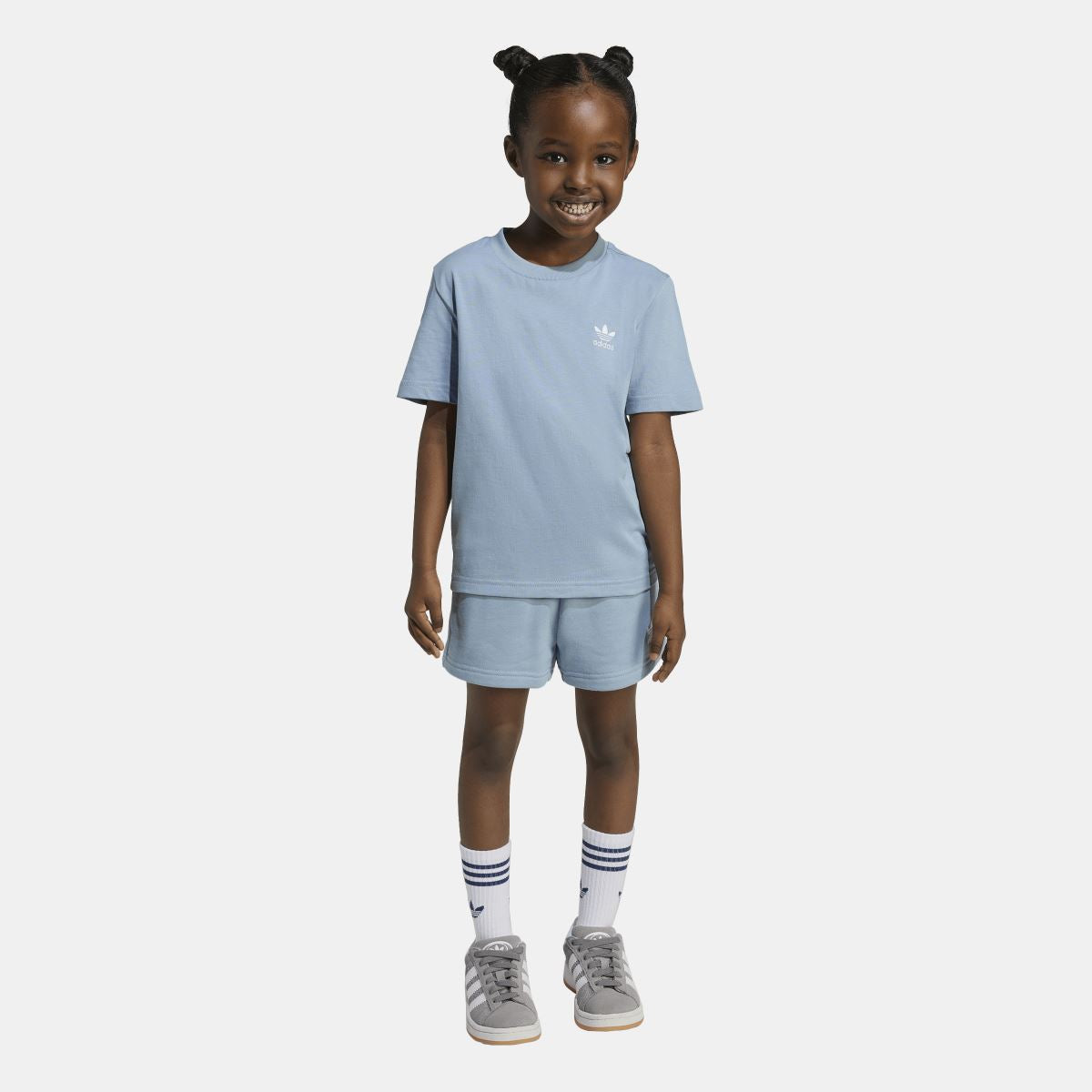 Light blue adidas kids T-shirt and shorts set on model, crew neck and logo detail.