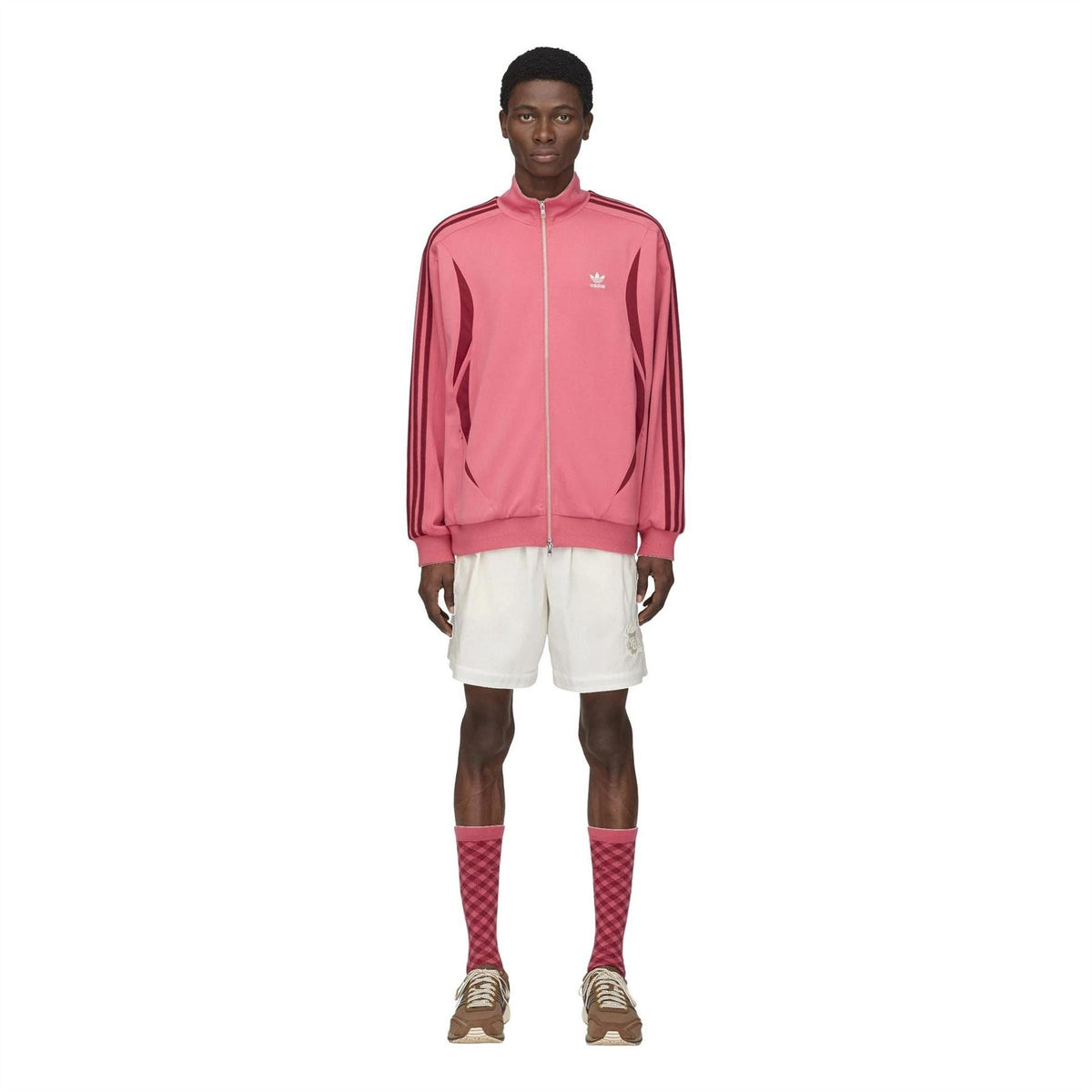 Off-white football shorts on model with elastic waistband and straight hem