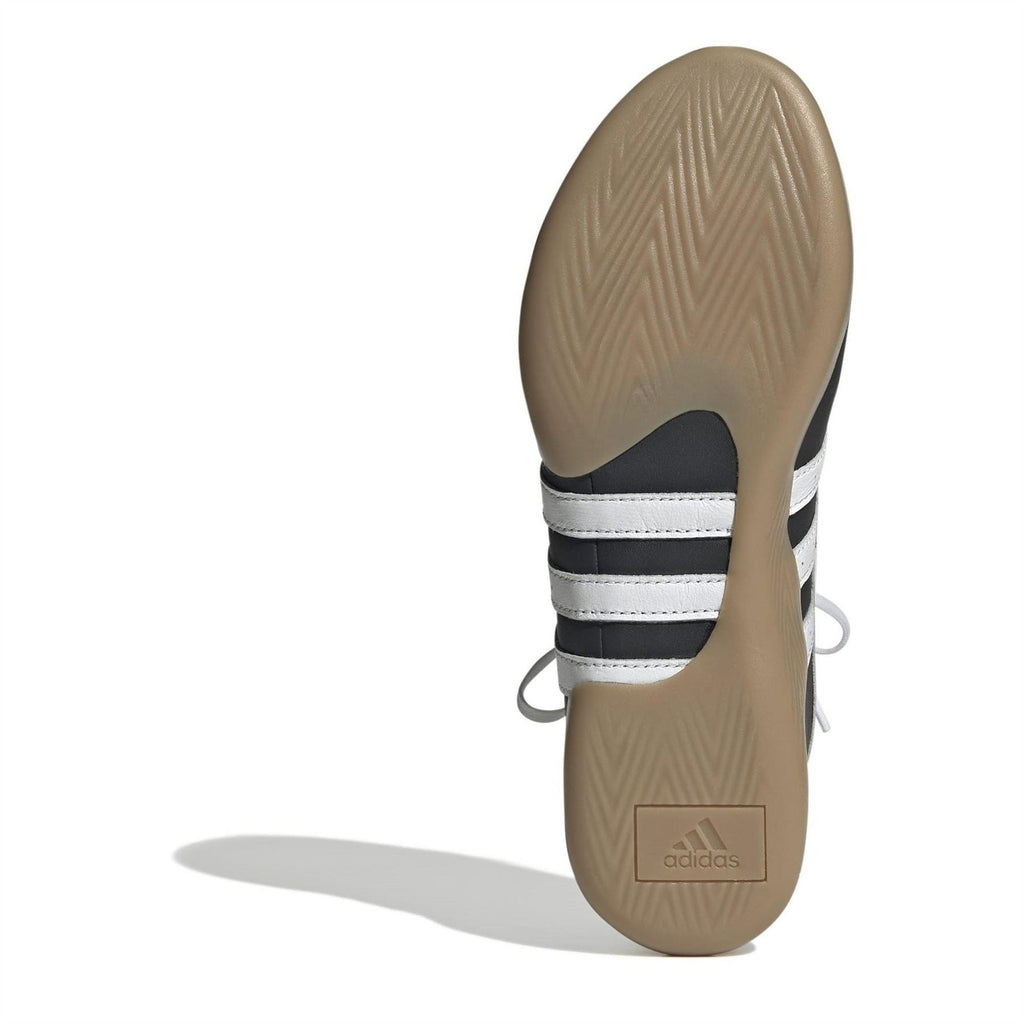 Taekwondo sneakers heel and outsole view with striped midsole detail and tan rubber sole