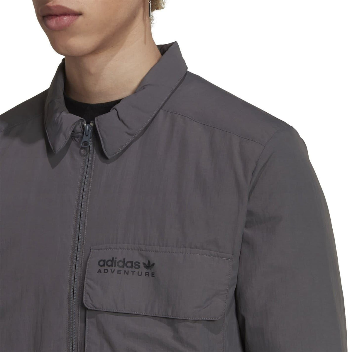 Grey adidas Originals shirt-jacket close-up of stand collar and chest logo on zip front