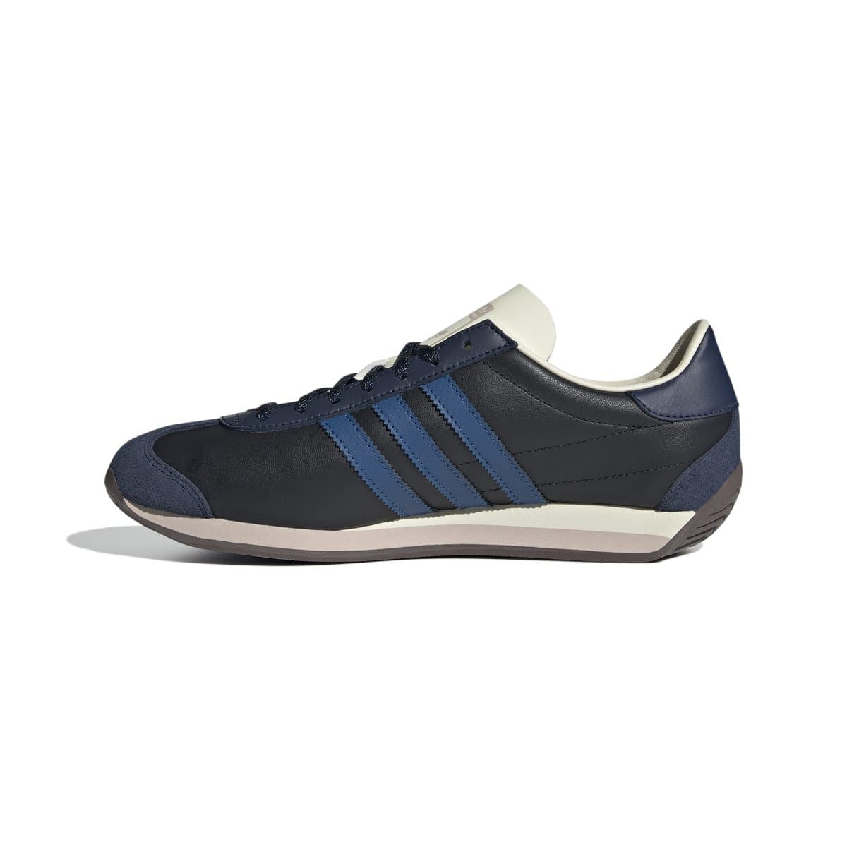 Low-top navy/black trainer with blue stripes, cream collar, and rubber cup sole