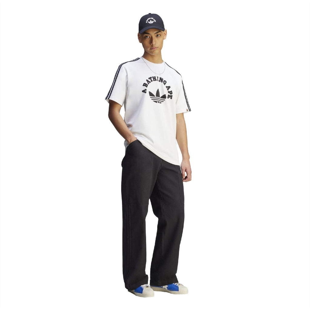 White graphic T-shirt on model with A BATHING APE logo, black stripes on sleeves