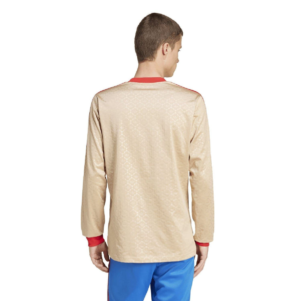 Beige adidas Originals jersey back view with red cuffs and subtle patterned fabric