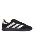 Black adidas trainers with white three stripes, black laces, and low-profile sole