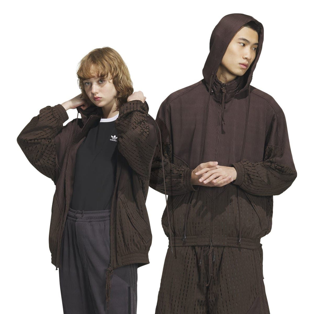 Brown hooded jacket on model, front view, with perforated texture and adjustable hood cords
