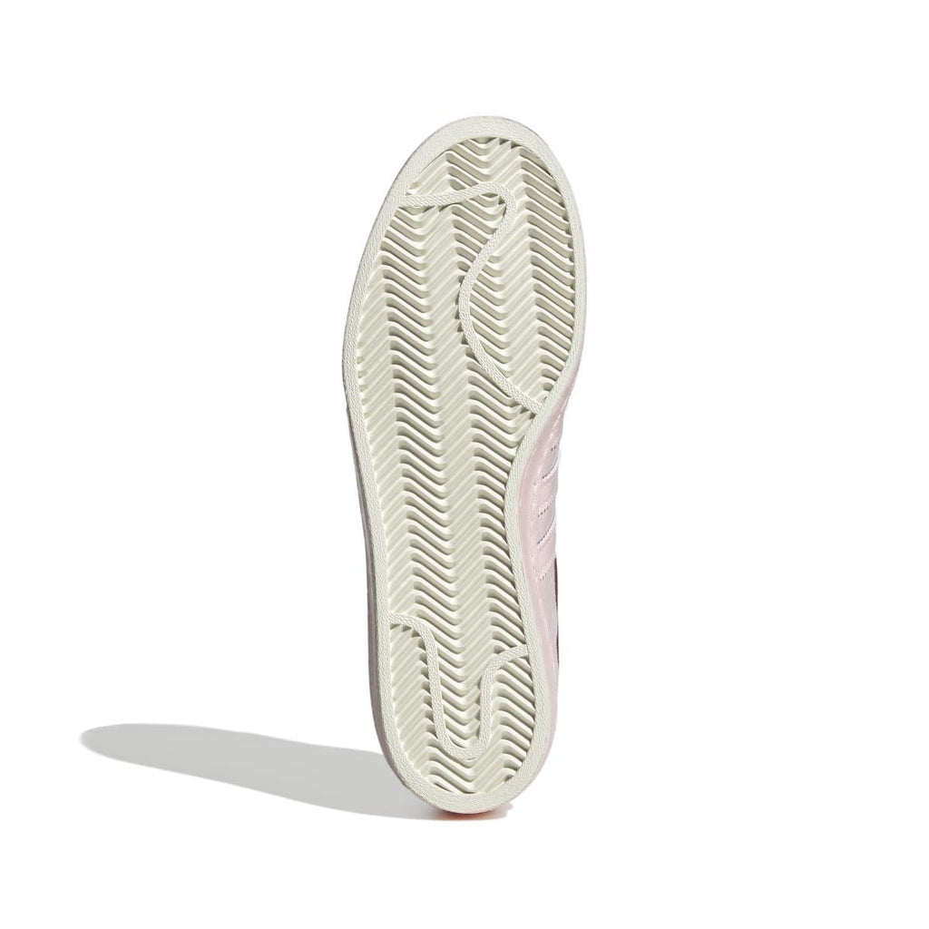 Shoe outsole with textured tread in off-white with pale pink side edge