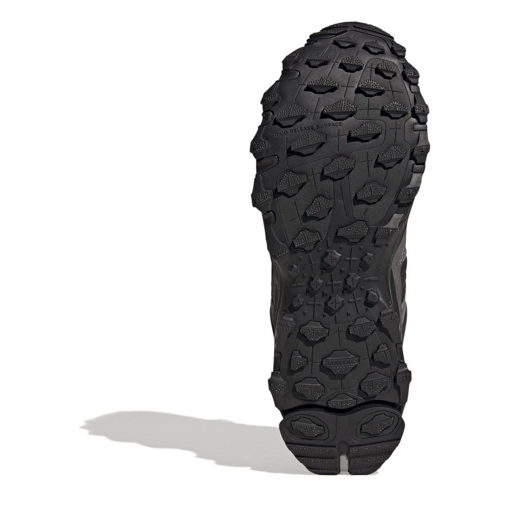 Black adidas sneaker outsole with deep traction pattern.