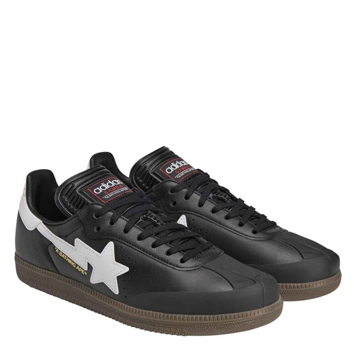 Black adidas Originals low-top sneakers with white star emblem, lace-up, and gum sole