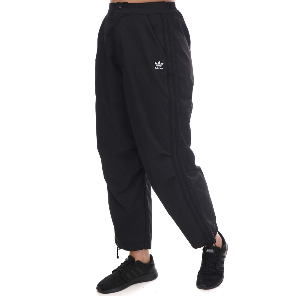 adidas Originals Adicolor Classic woven track pants with elastic waistband and side pockets, black with white stripes.