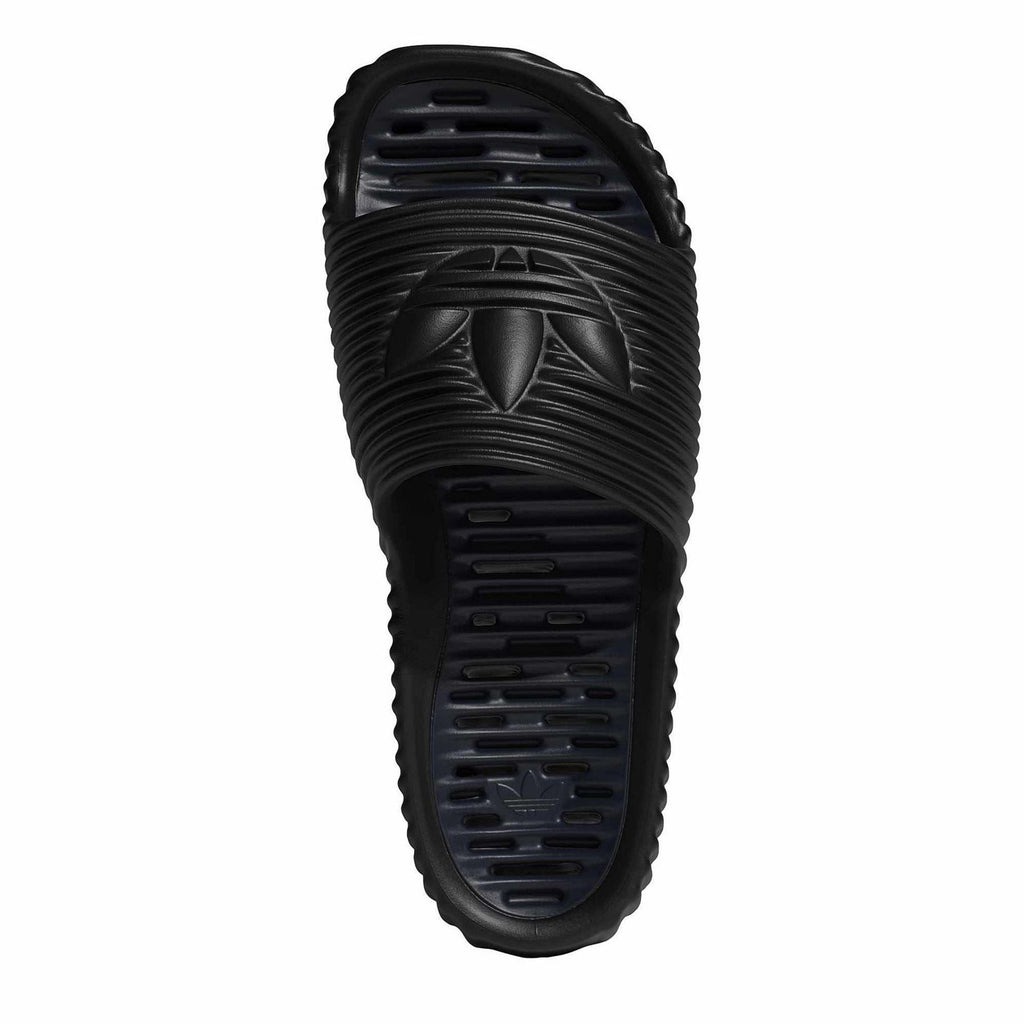 Core Black outsole view of slide sandal with tread pattern and adidas mark