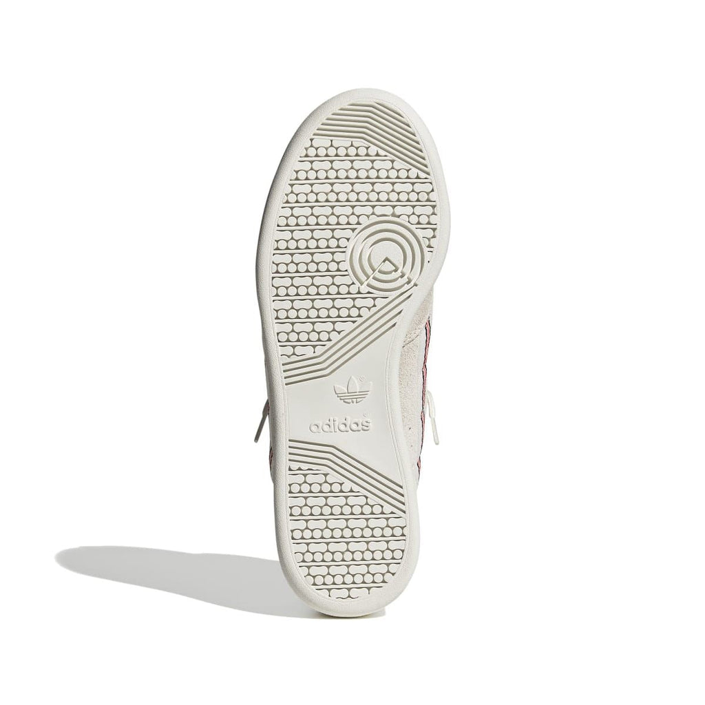 Light beige trainer outsole with textured tread and circular adidas logo mark