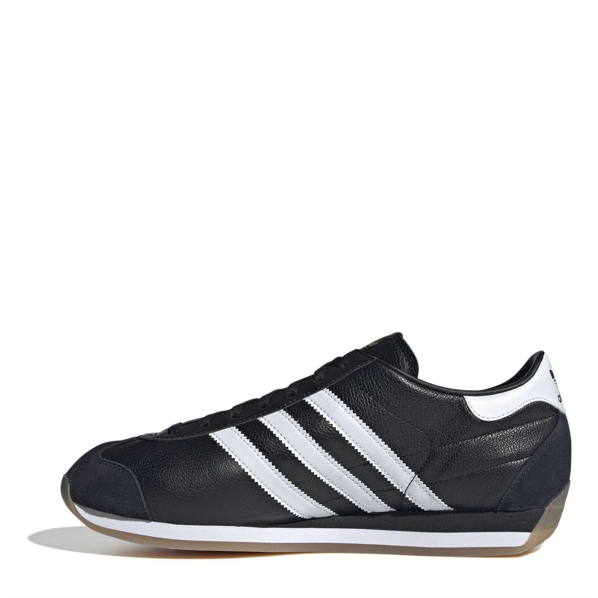 Black low-top sneakers with white triple stripes and lace-up closure, gum outsole.