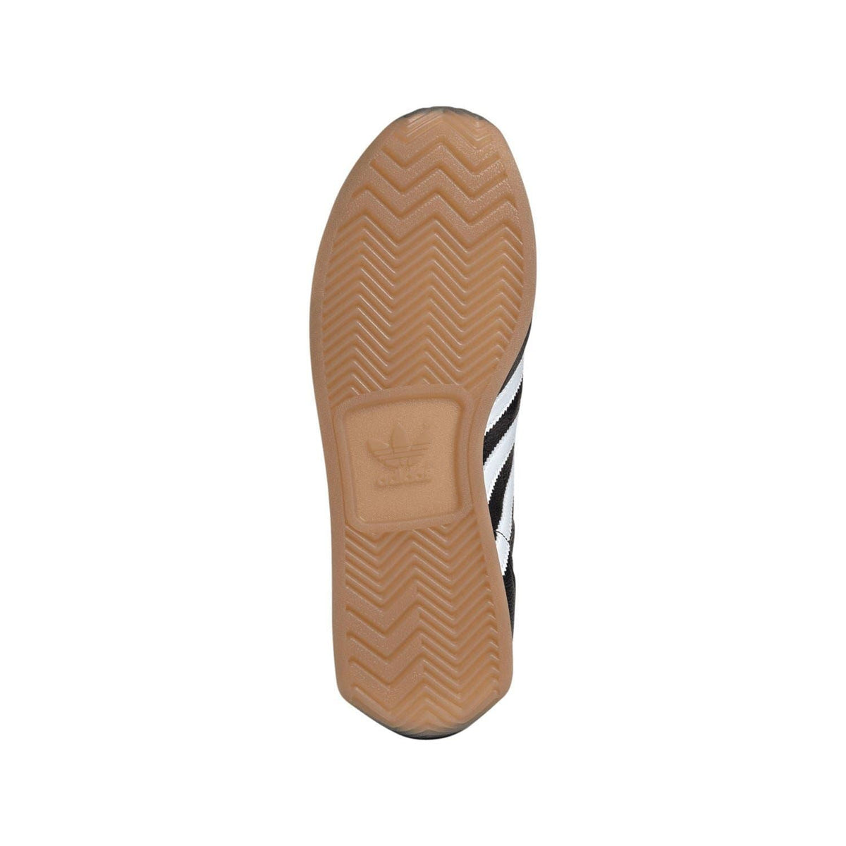 Gum rubber outsole with zigzag tread and white adidas stripe detail on toe