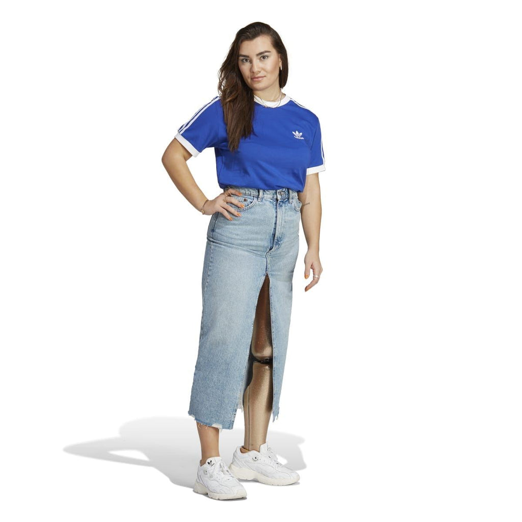 Blue adidas Originals t-shirt worn with light wash denim jeans and white sneakers