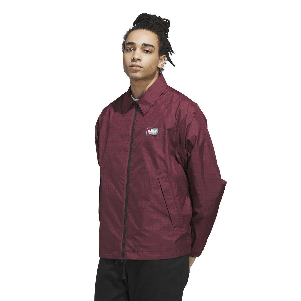 Shadow red coach jacket with zip front and stand collar, chest logo patch, relaxed fit