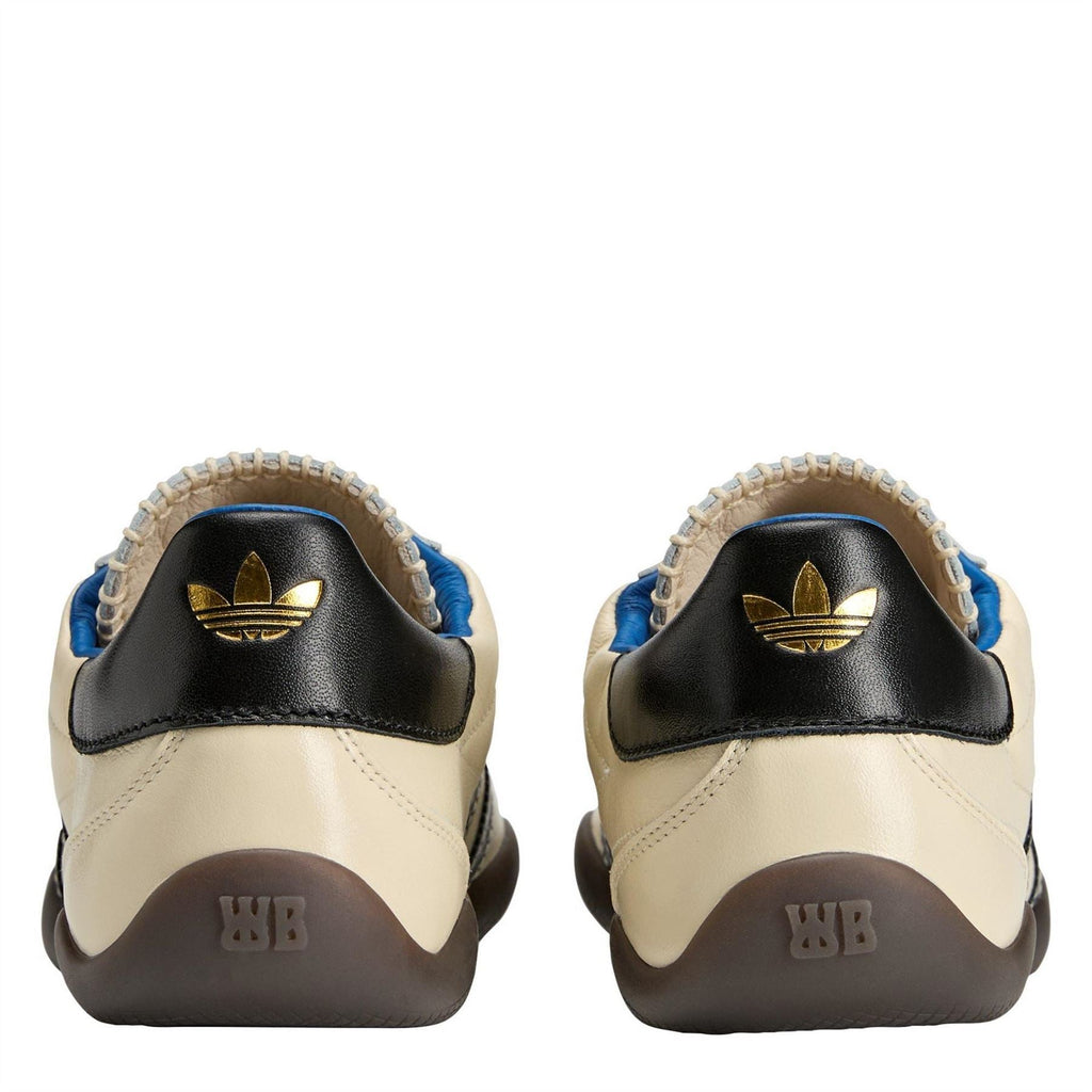 adidas Originals sneakers heel close-up with gold adidas logo, black panel, and brown tread