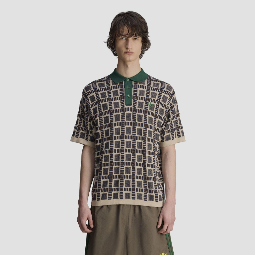 Mens polo shirt with green collar; sand base with navy geometric square pattern.