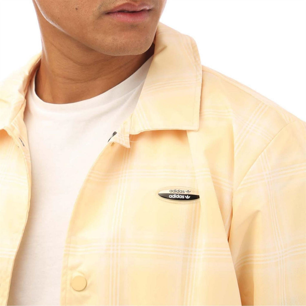 adidas Originals Coach Jacket, a stylish men's coat with a sporty design, featuring the iconic adidas logo and lightweight fabric