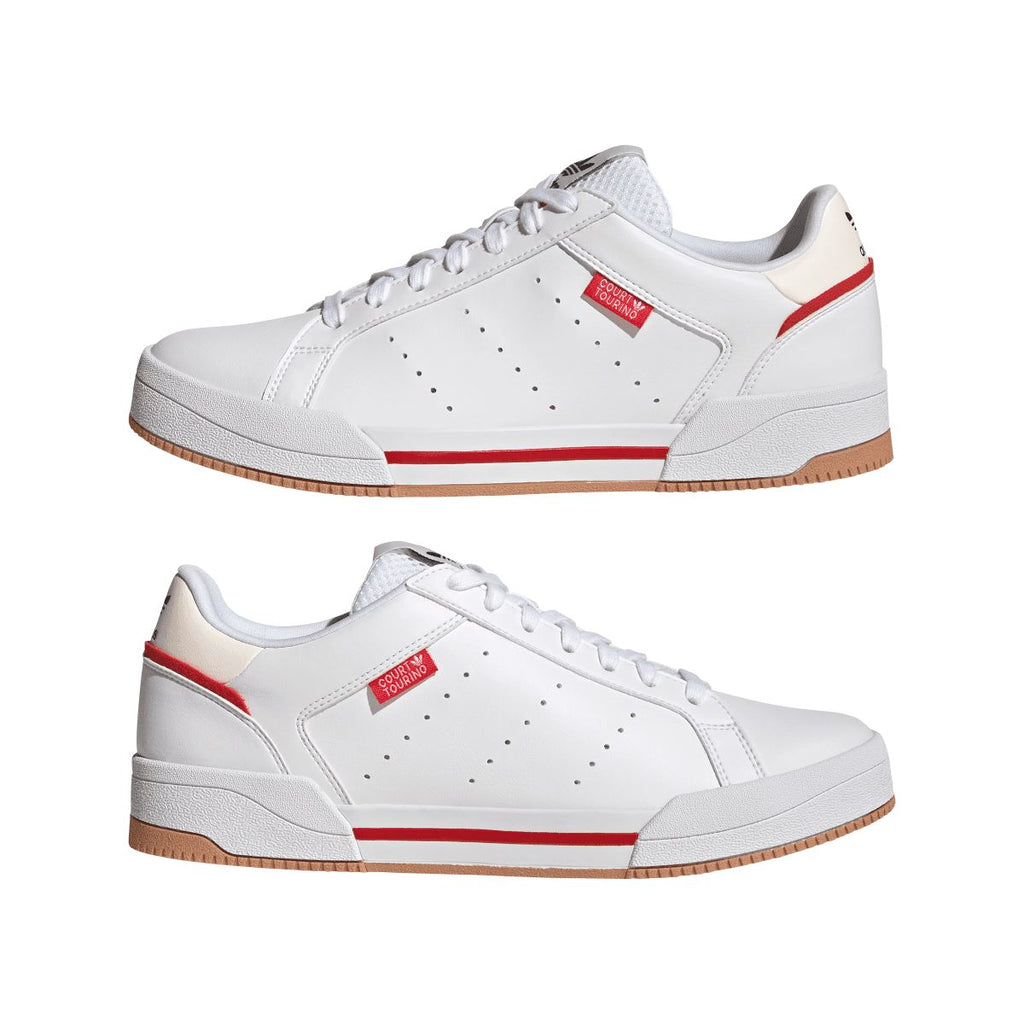Pair of white adidas low-top trainers with red stripes and gum rubber soles