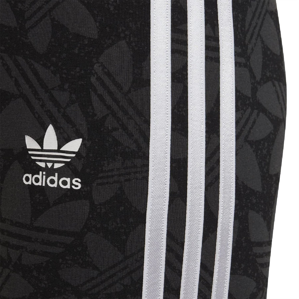 Black adidas leggings close-up with adidas logo and side white triple stripes